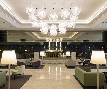 Chandelier lights & table at Hotel Emperador Buenos Aires