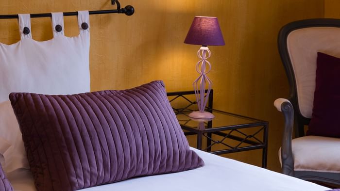 Close up of a pillow on comfy bed at Hotel Le Village Provencal