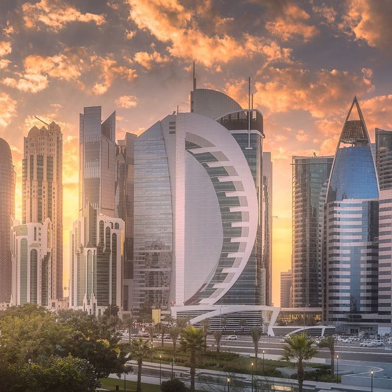 Skyscrapers in Doha, near Warwick Hotels and Resorts, showcasing unique architecture and vibrant streets