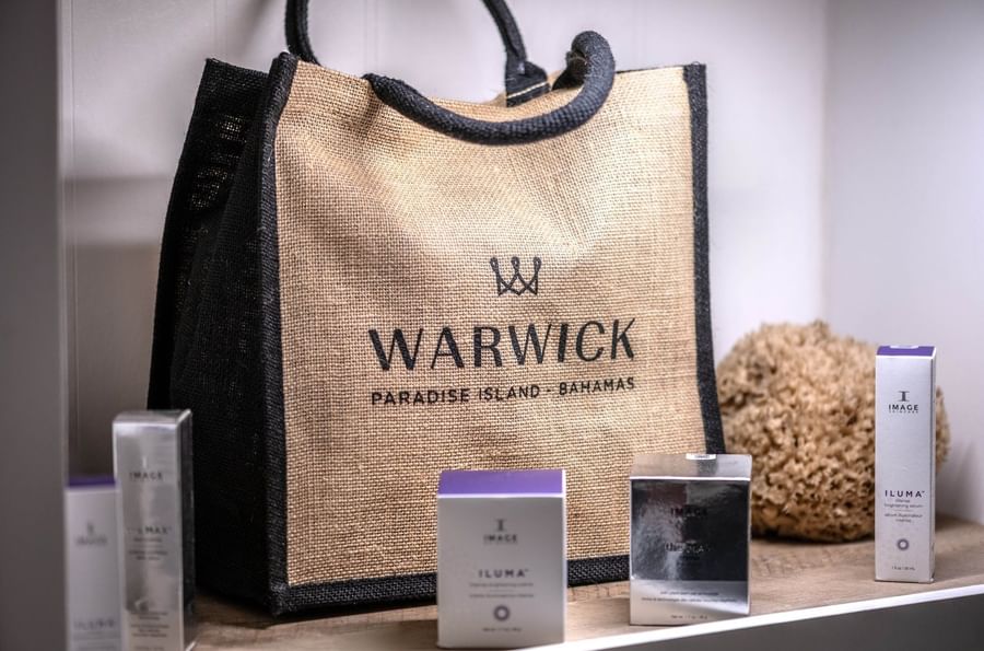 Burlap bag by skincare boxes under soft light surrounding a natural sponge at Warwick Paradise Island Bahamas