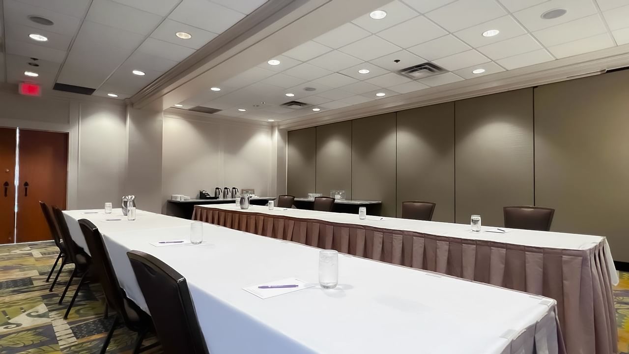 Two long boardroom tables with presentation screen