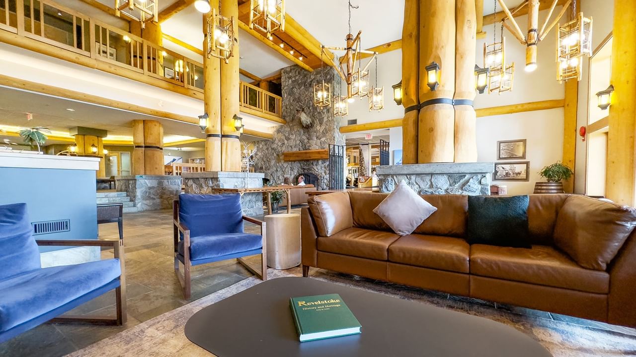 Lobby of Coast Hillcrest Hotel with couch, arm chair, and tables
