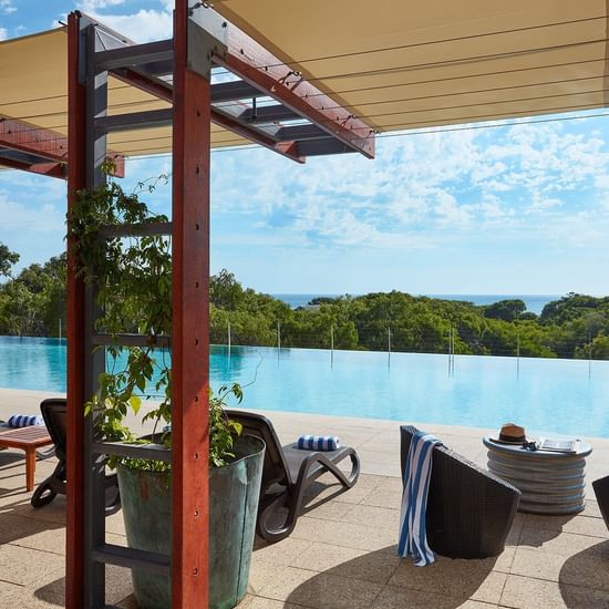 Sun lounges by the pool at Pullman Bunker Bay Resort