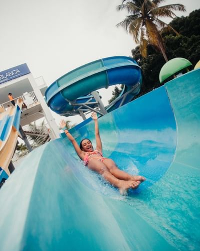 Girl sliding and enjoying on a slide at Playa Blanca Beach Resort