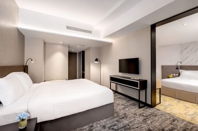 Interior of Premier Family Quintuple Room with carpeted floors at Park hotel Hong Kong