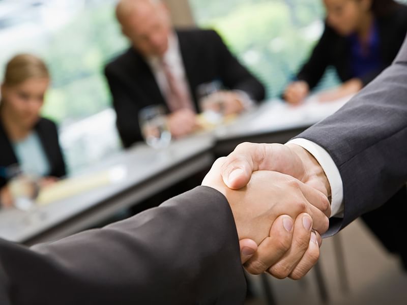 Businessmen shaking hands at Warwick Brussels 