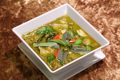 Thai Green Curry with Chicken served on a table at Amora Neoluxe Hotel Bangkok
