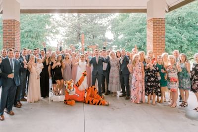 wedding group posing with clemson tiger mascot