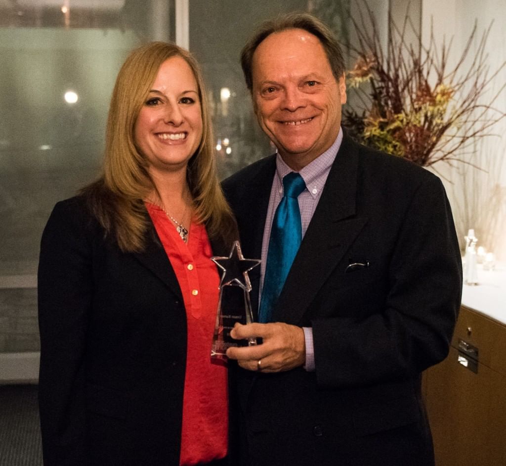 Couple posing with an award at The Somerset on Grace Bay