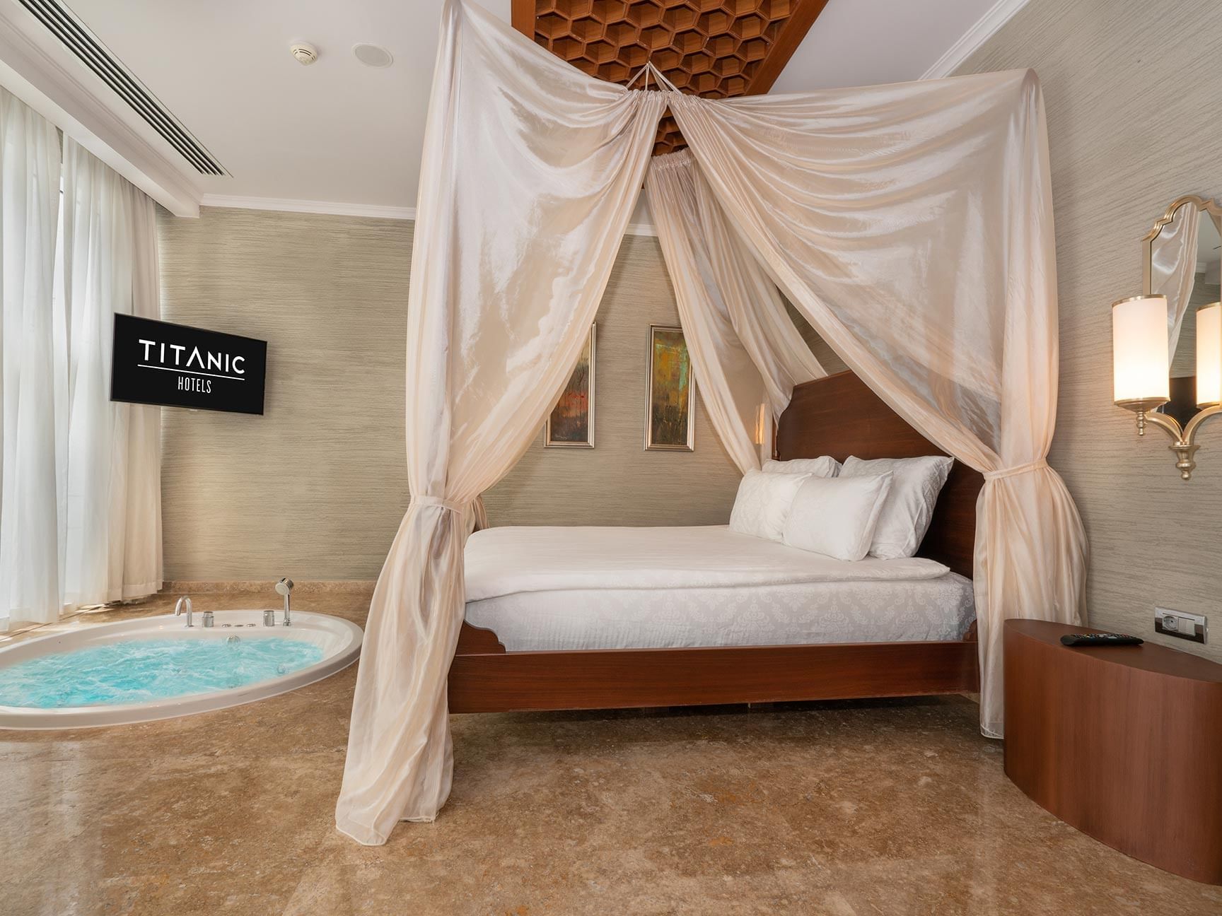 Comfy bed and jacuzzi in Ottoman Spa Suite at Titanic Deluxe Golf Belek