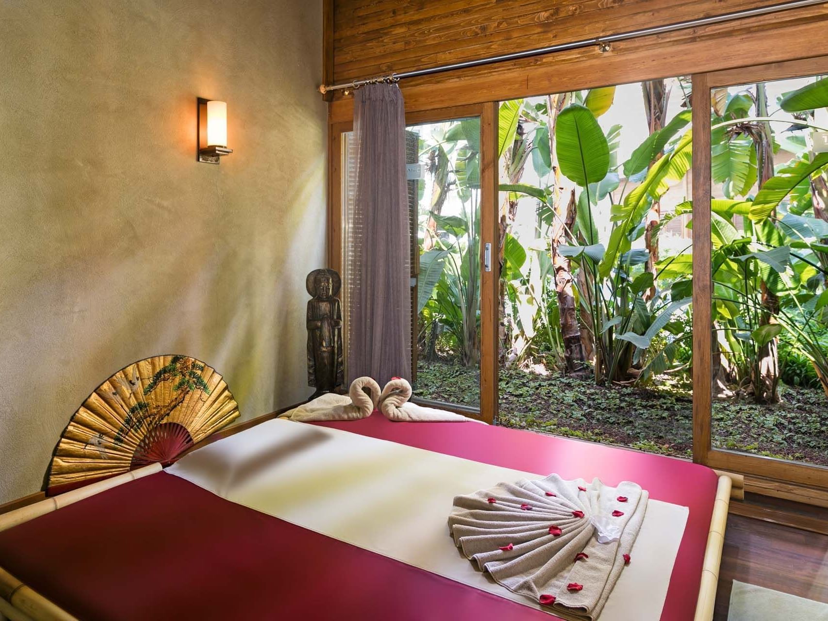 Massage bed with a garden view in a spa at Titanic Deluxe Golf Belek