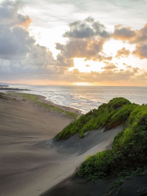 Sigatoka Sand Dunes National Park with Golden sunset by rolling sand dunes near the ocean near The Naviti Resort - Fiji