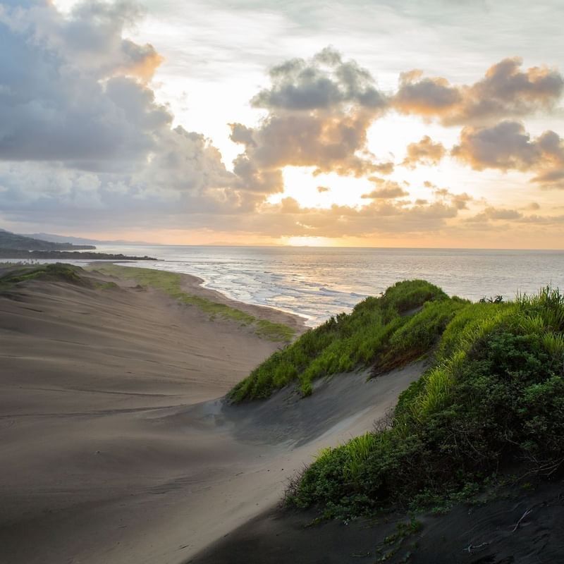 Sigatoka Sand Dunes National Park with Golden sunset by rolling sand dunes near the ocean near The Naviti Resort - Fiji