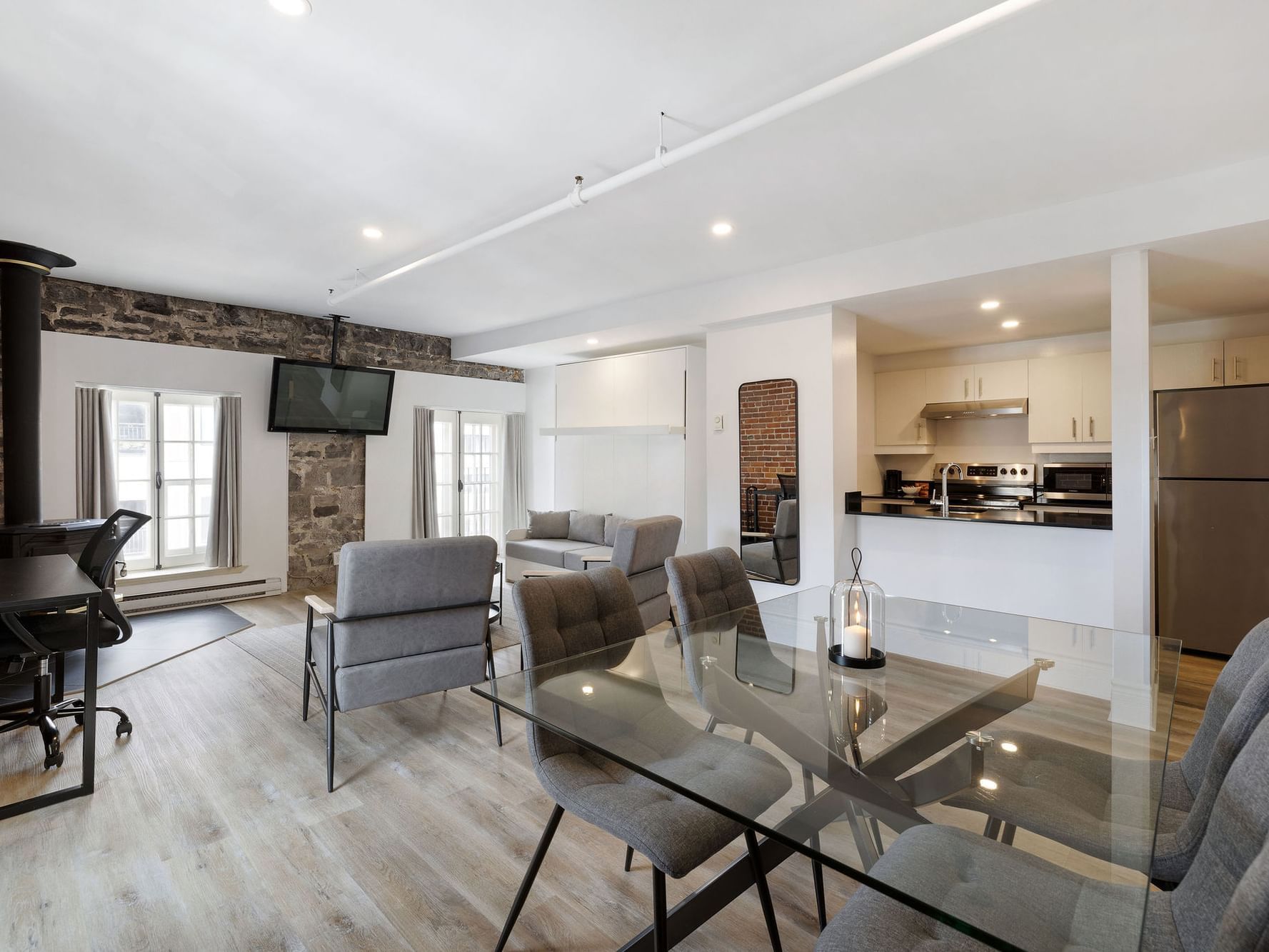 Dining table and kitchen by the TV lounge area in Superior Suite at Hotel Port Royal