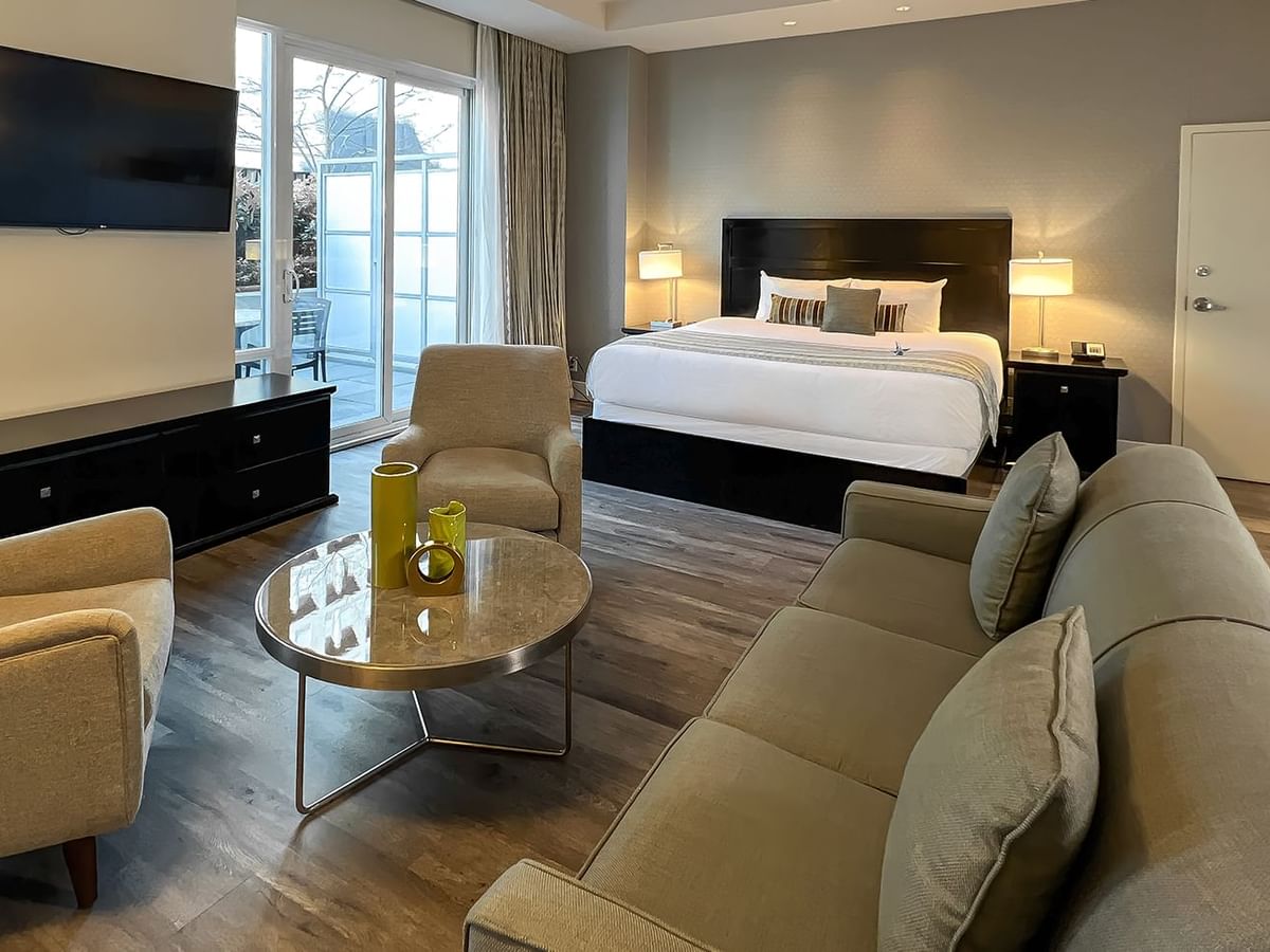Coast Premium King Balcony & View room with sitting area, TV, lamps, and bed