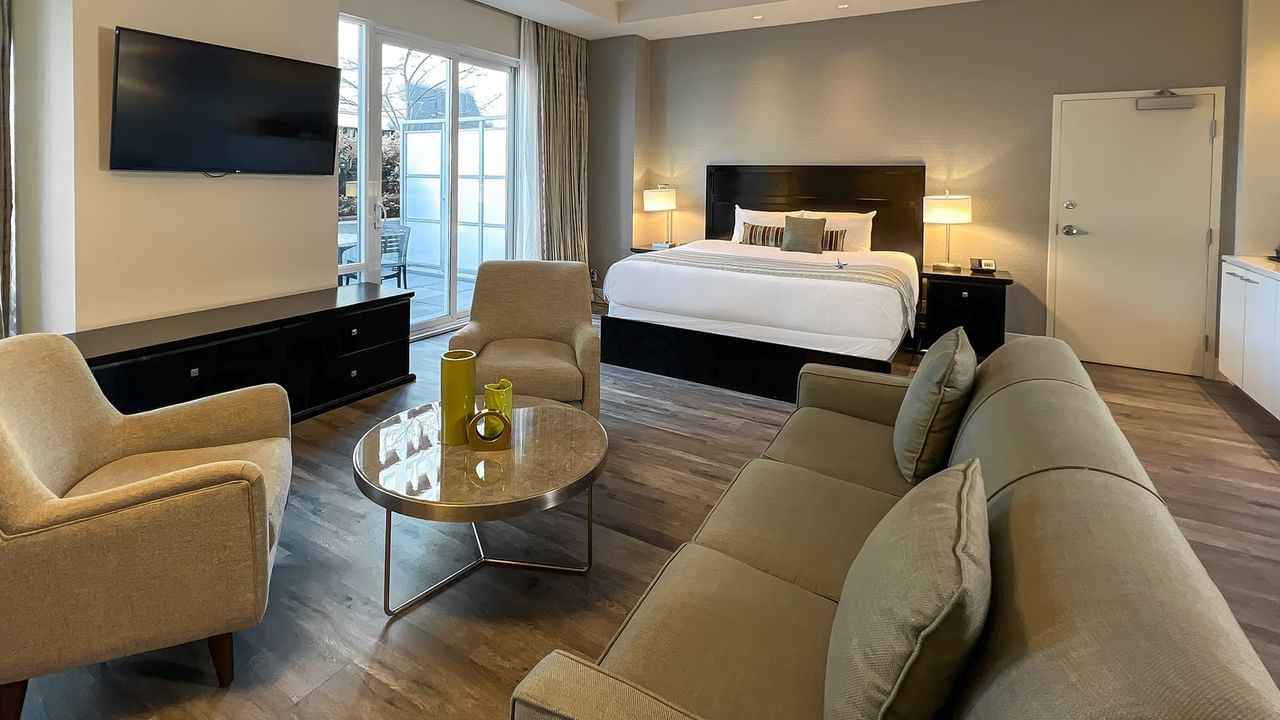 Coast Premium King Balcony & View room with sitting area, TV, lamps, and bed