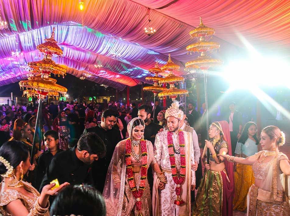 bride and groom at the entrance of a grand Indian wedding hall - Lexis MY