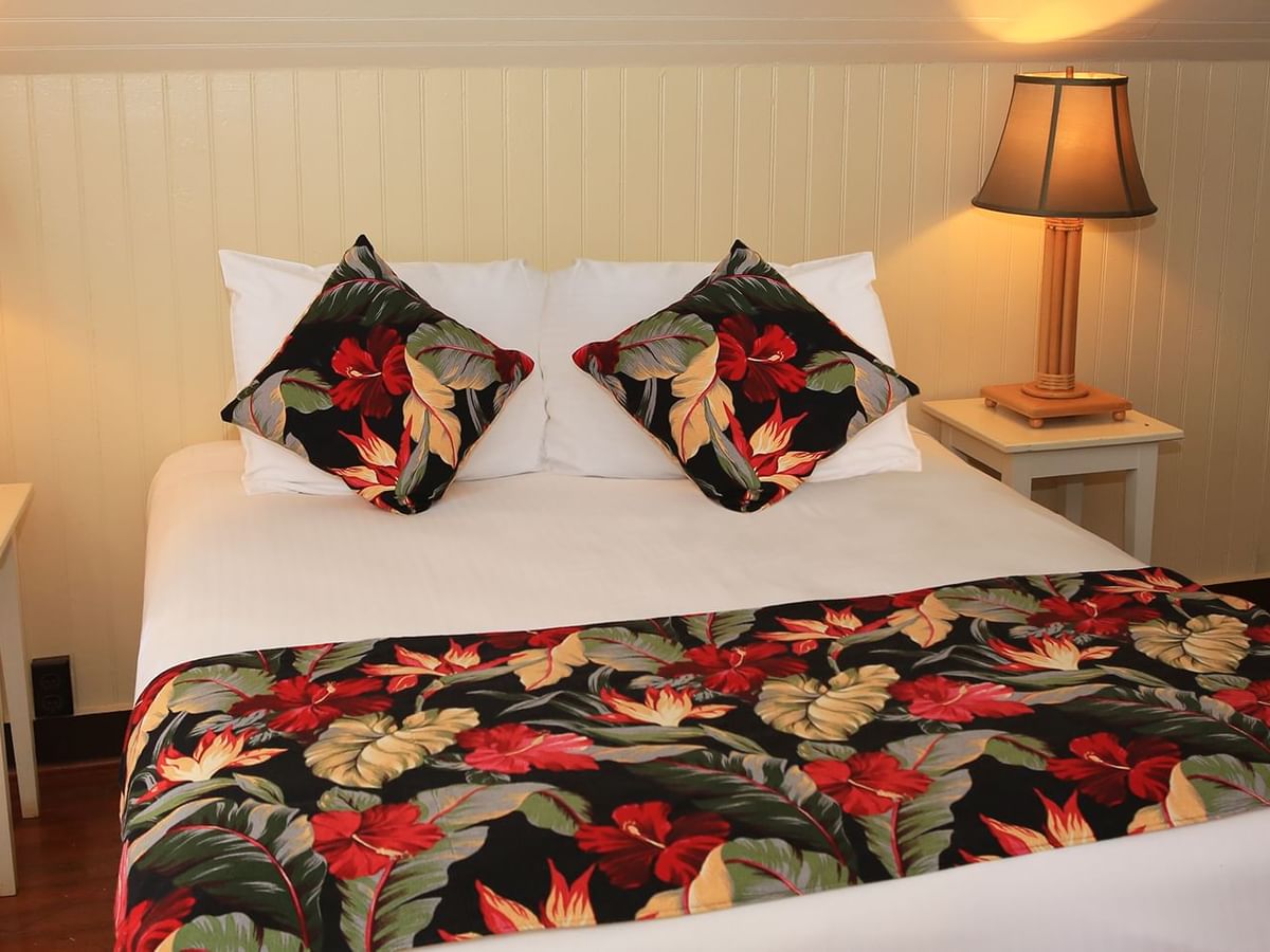 Bedroom with lamp, bed, and pillows