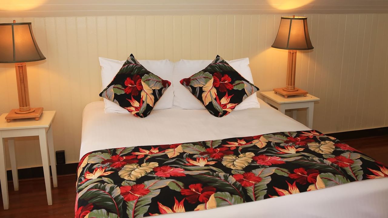 Bedroom with lamp, bed, and pillows