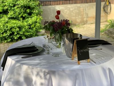 dine table in the garden with flowers at The Inn of Waterloo