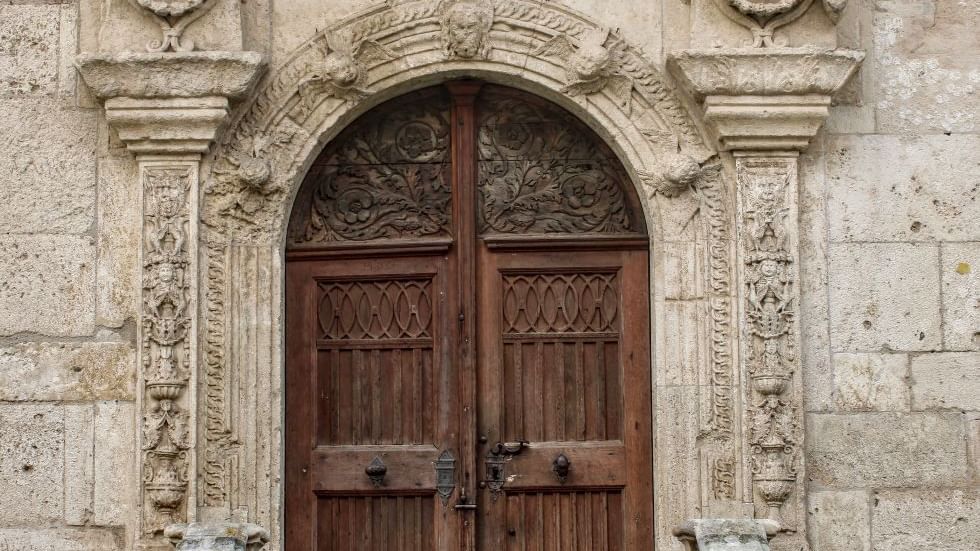 A wooden door of Murat Castle near Falkensteiner Hotels