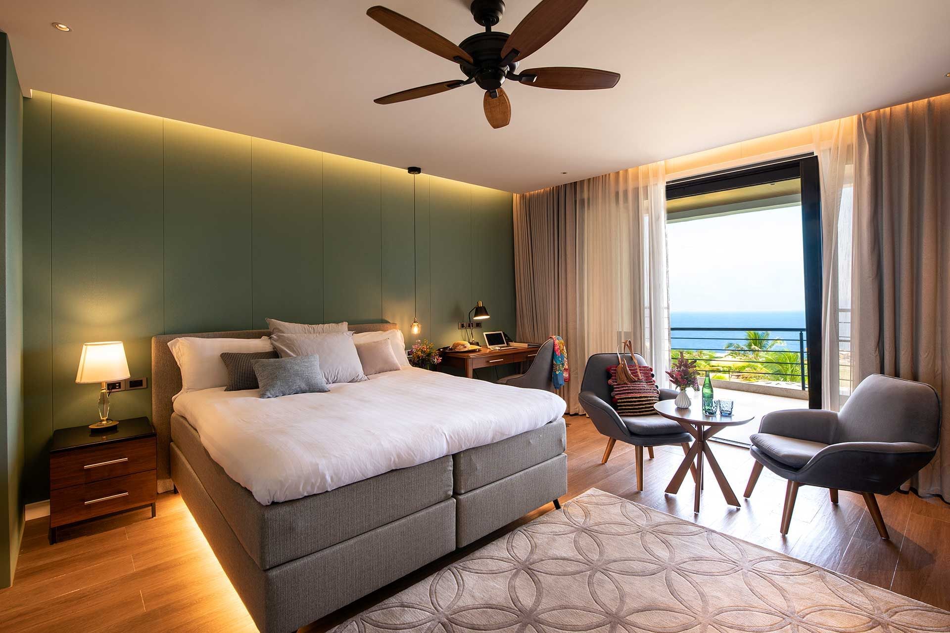 Bed & lounge area in Golden Rock Suites at Golden Rock Resort