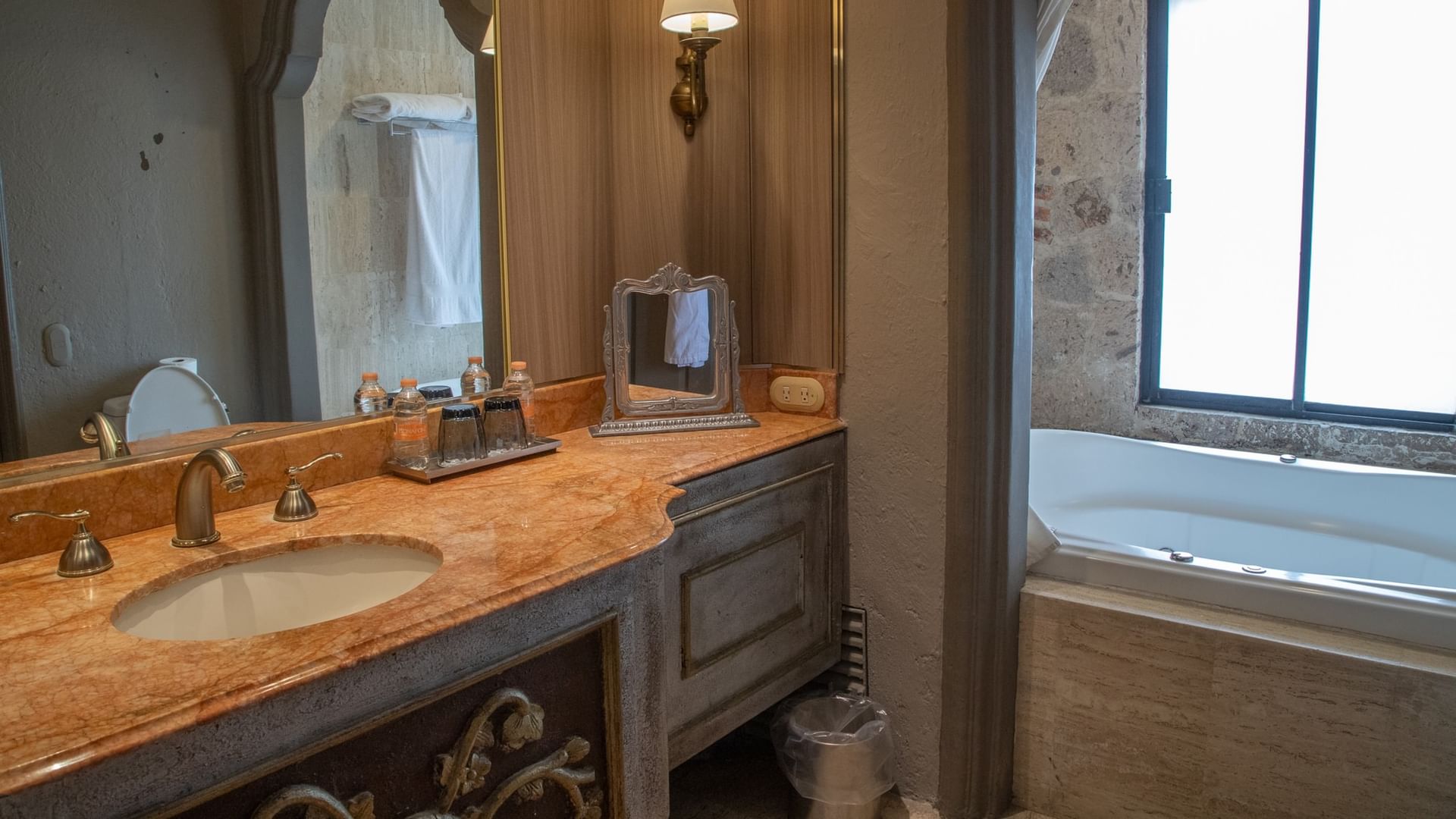 King Governor Suite bathroom with marble vanity, soaking tub, and elegant fixtures at Quinta Real Guadalajara