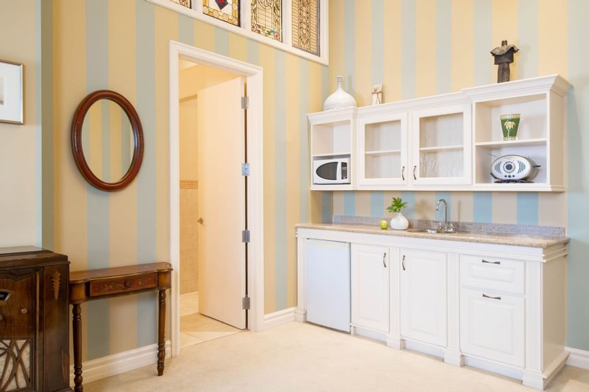 Kitchenette with white pantry & appliances in King Executive King William at Retro Suites Hotel