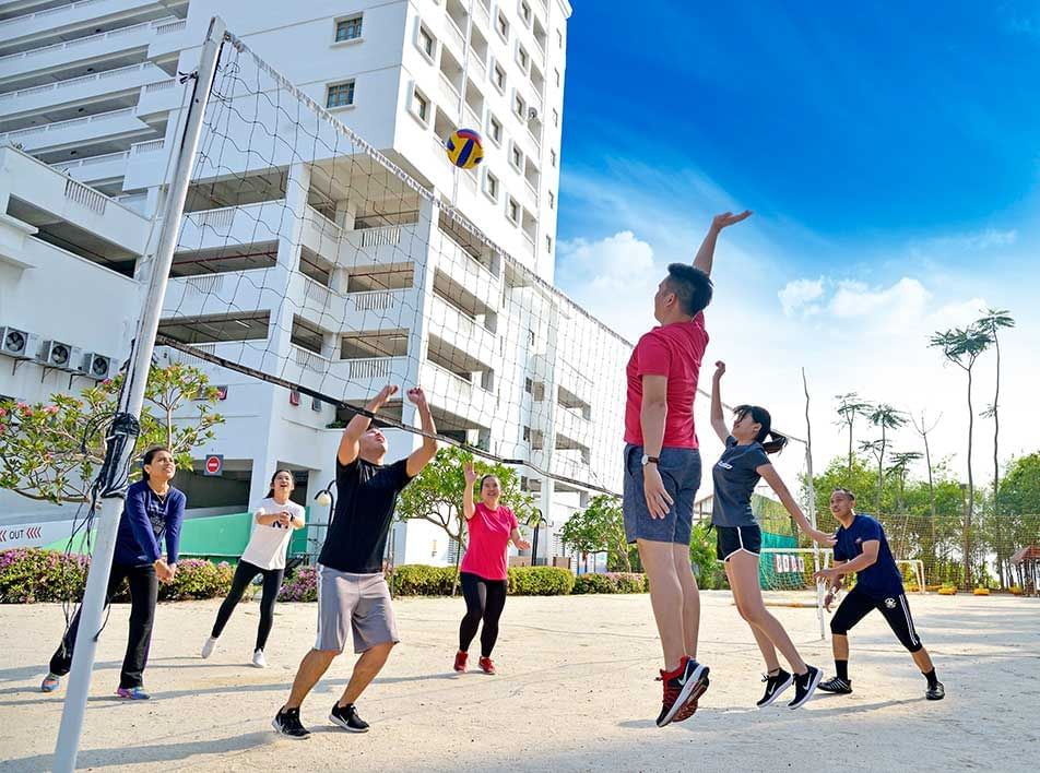 family members having fun playing volleyball - Lexis MY