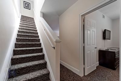 A stairway by corridor of guest room at Artmore Hotel