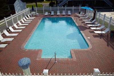Lounge chairs by the Sunny pool area at Breezeway Boutique Hotel
