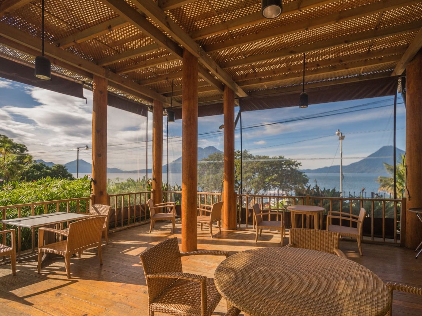 Porch lounge area with wooden interior overlooking the mountains in Deck at Porta Hotel del Lago