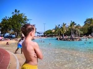 A boy enjoying the view of the Settlement Cove Lagoon near The Sebel Brisbane Margate Beach