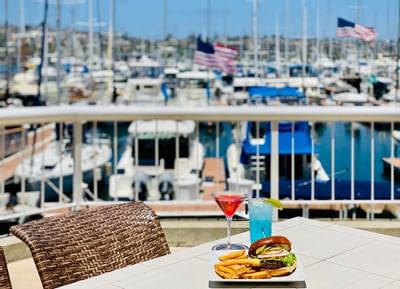 Burger & drinks on the patio with Marina View at Bay Club Hotel