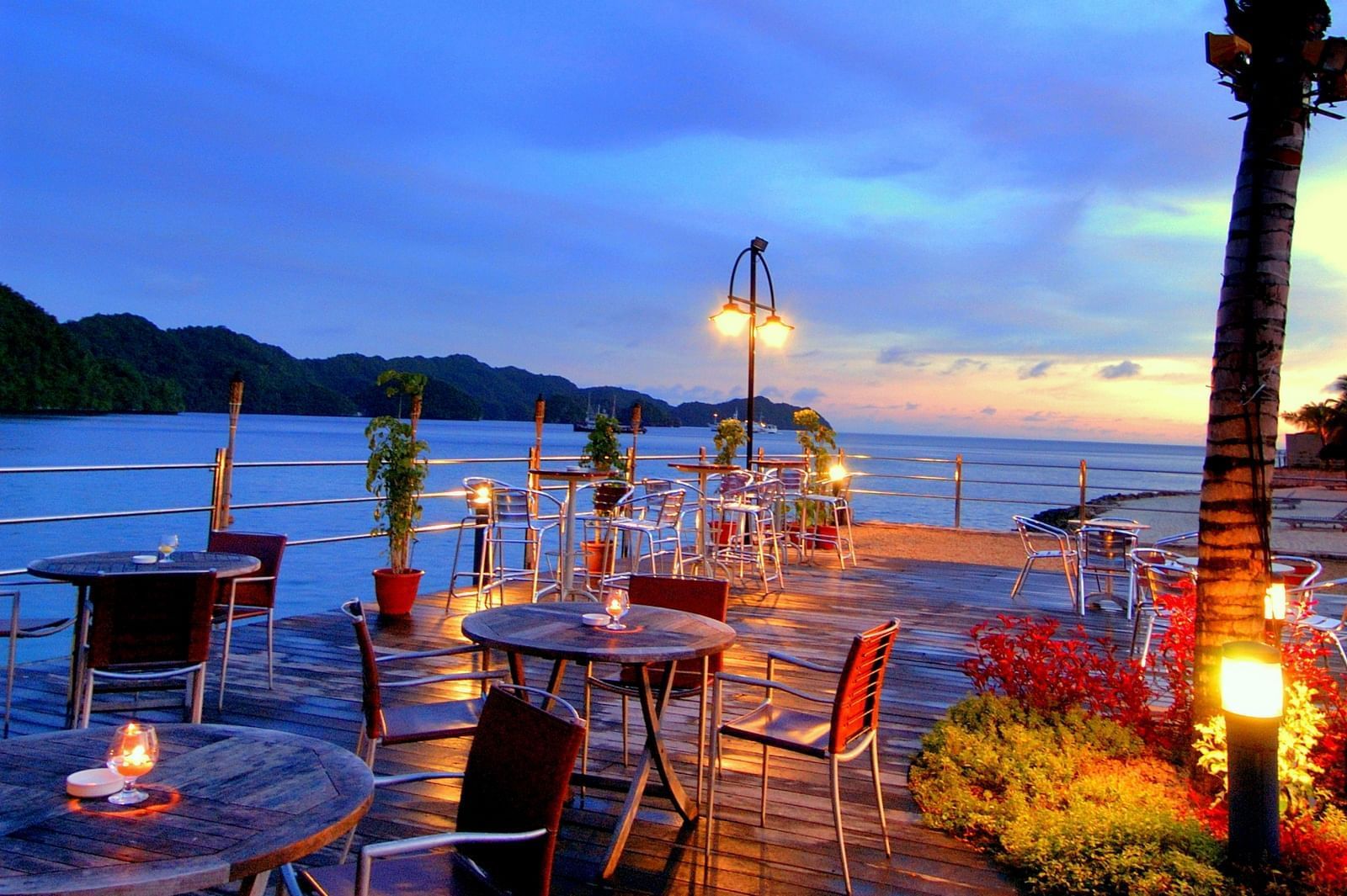 Outdoor dining area in Breeze Bar at Palau Royal Resort at dawn