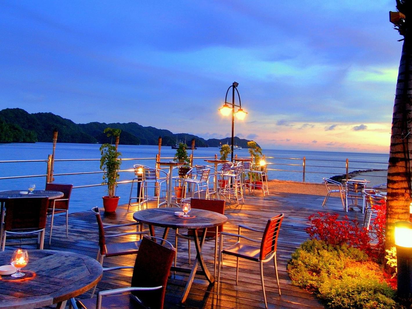 Outdoor dining area in Breeze Bar at Palau Royal Resort at dawn