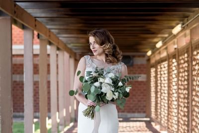Portrait of a bride posing with a bouquet at UMass Lowell Inn