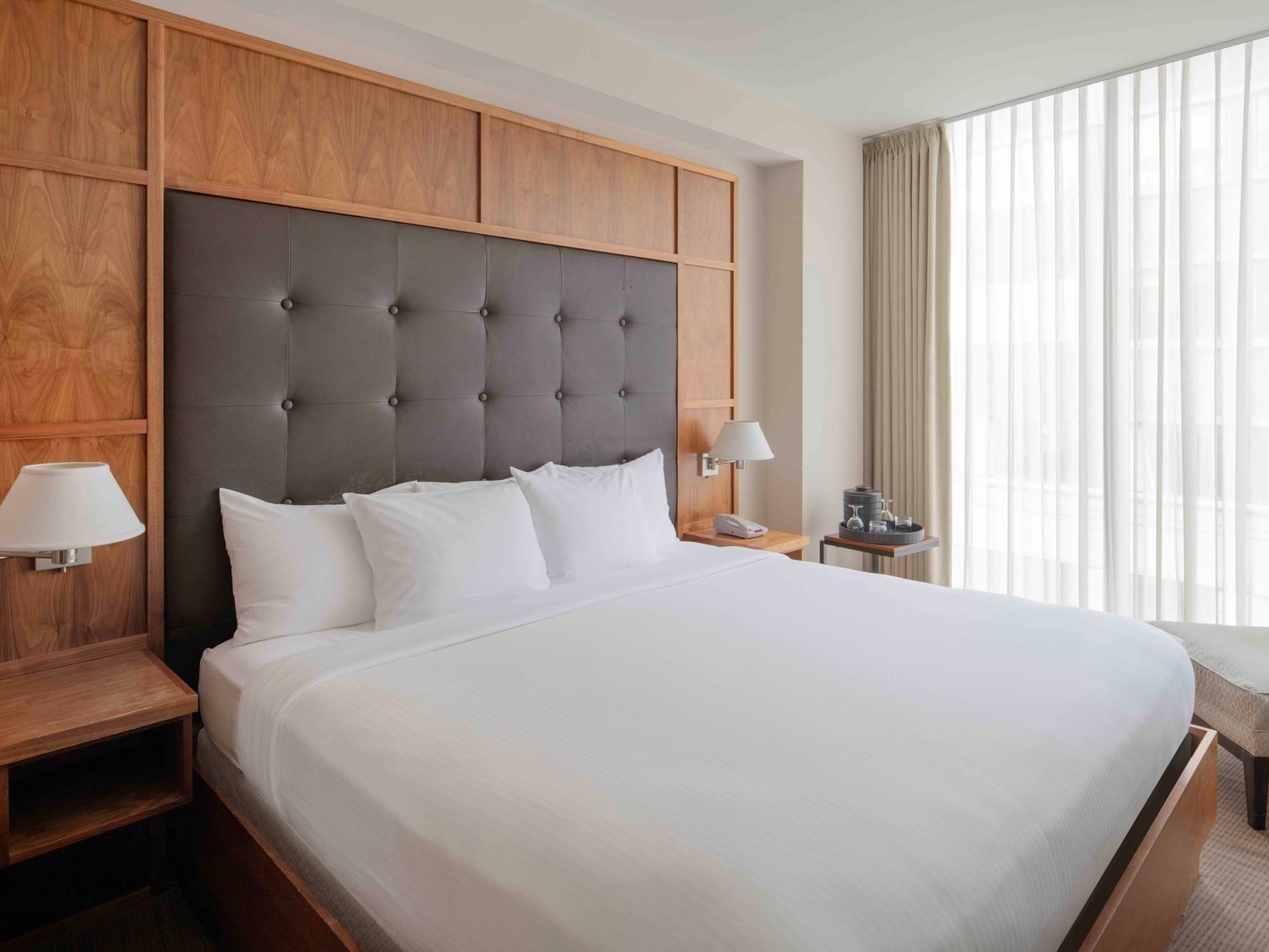 King bed with cushioned headboard in Executive Junior Suite at Portland Harbor Hotel