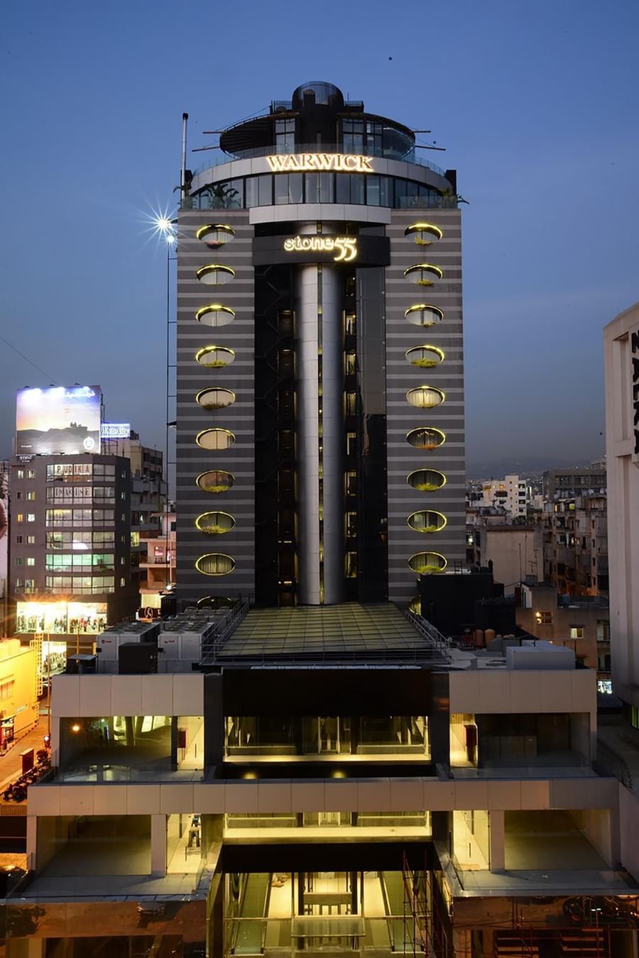 Exterior view of Rooftop Restaurant with oval glowing windows at Warwick Stone 55 - Beirut