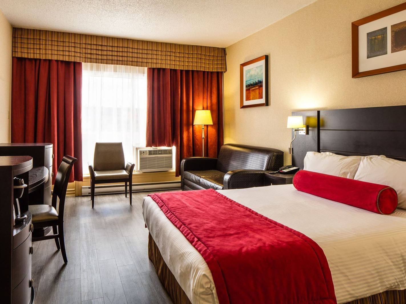 king bed in spacious hotel room with window