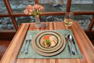 dining table with plate of food and wine glass