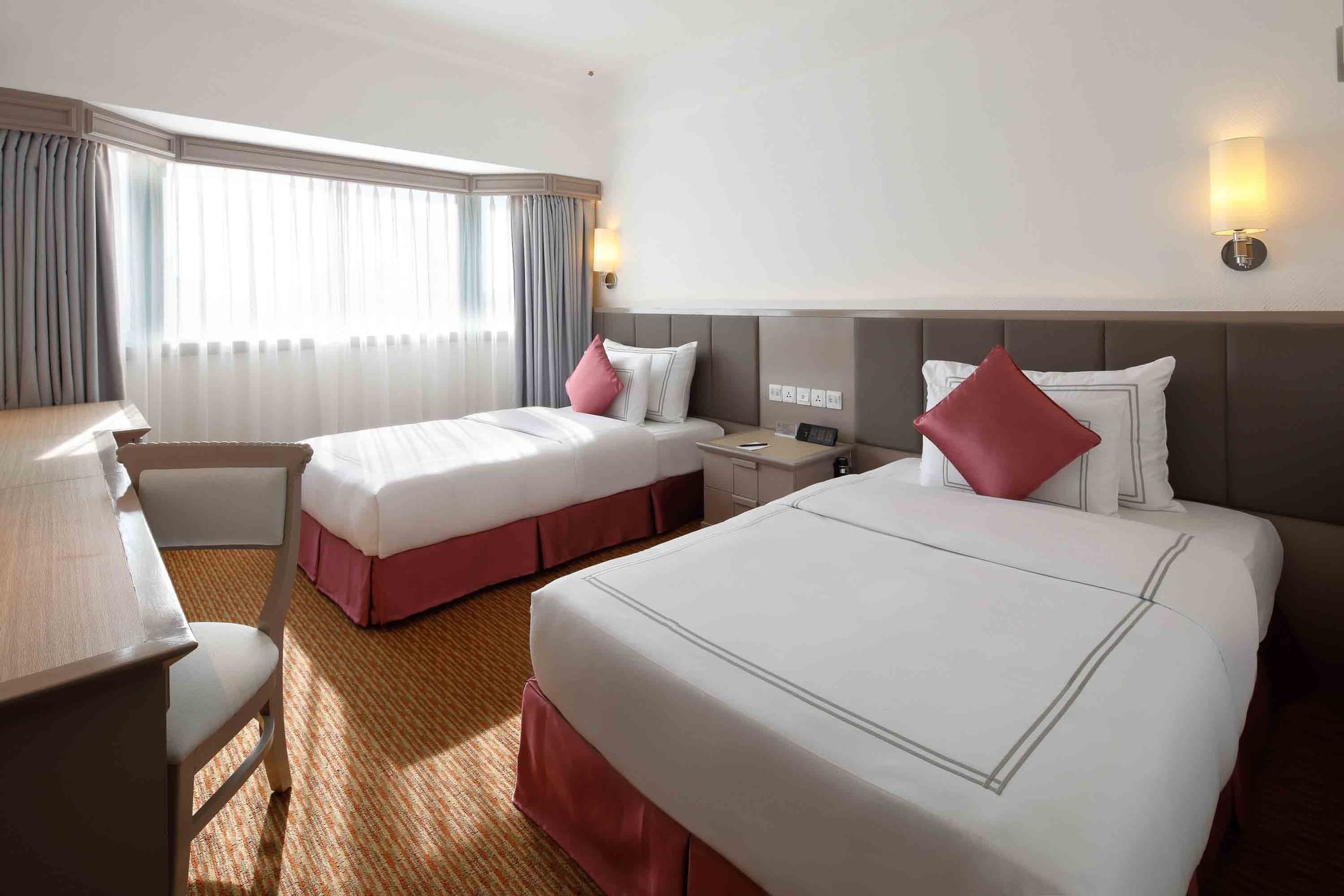 Interior of Deluxe City View Twin with carpeted floors at Sunway Hotel Hanoi