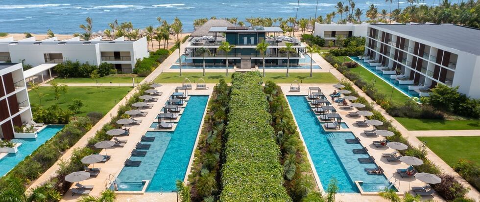 Exterior view of the hotel featuring pool, sea & amenities at Live Aqua Punta Cana