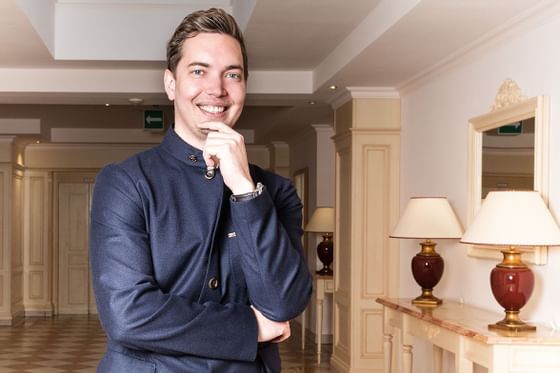 A young chef posing in a hallway at Hotel Liebes Rot Flueh