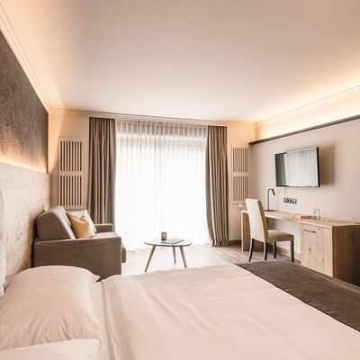 Bed, desk & lounge Family Superior Suite, Falkensteiner Hotels