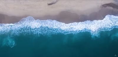 Aerial view of ocean waves with a sandy beach near Villa Premiere Boutique Hotel & Romantic Getaway