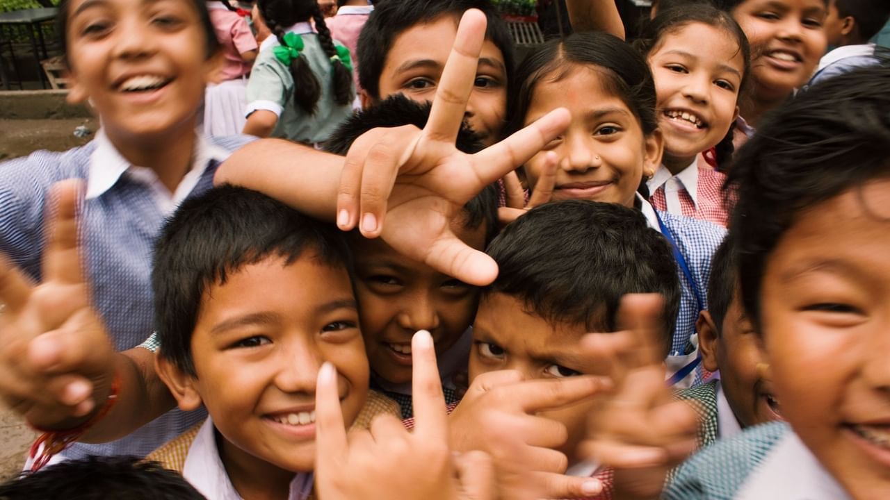 A group of kids smiling for photos