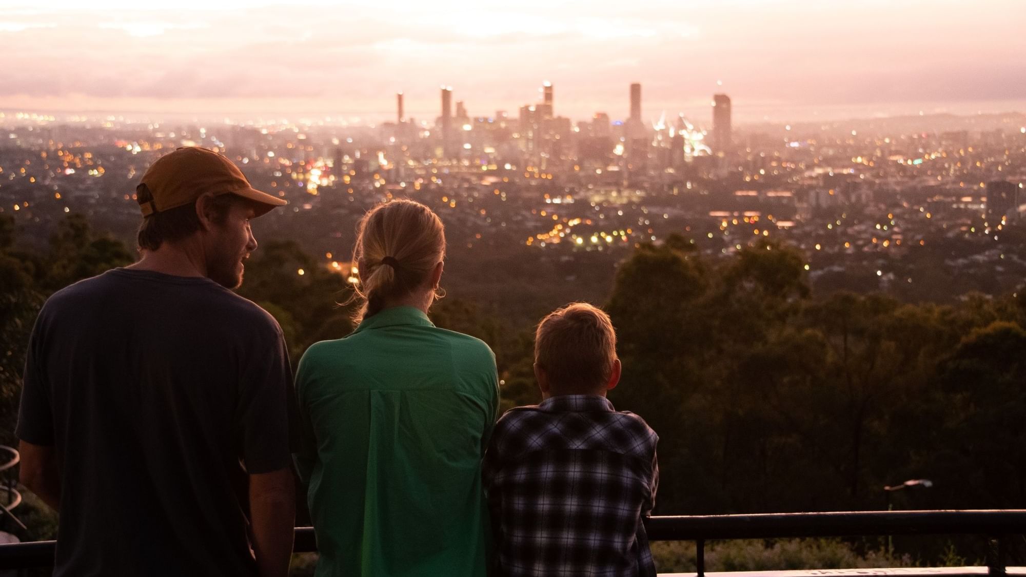 Family overlooking a cityscape at Mount Coot-tha near Sofitel Brisbane Central