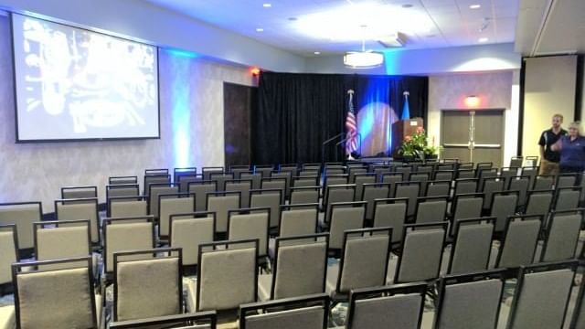 Rows of gray chairs set up for an event in Roosevelt Ballroom at Shangri-La Monkey Island