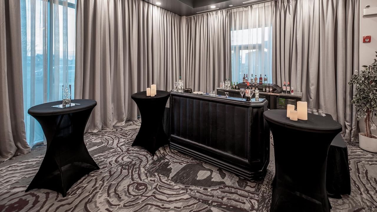 Event space set up with round tables and candles.